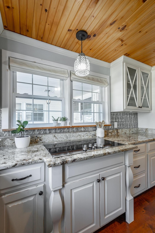 kitchen with white cabinetry, wood ceiling, and tasteful backsplash