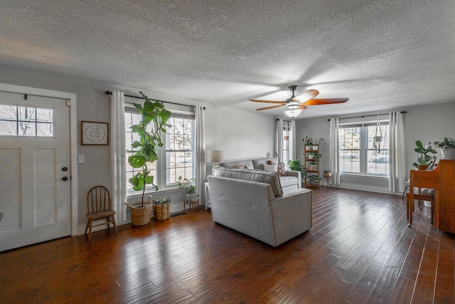 living room featuring ceiling fan and dark hardwood / wood-style flooring