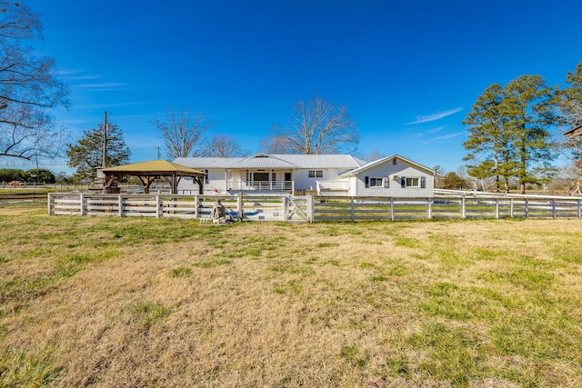 back of house with a gazebo and a rural view