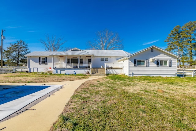 rear view of property with a porch and a yard