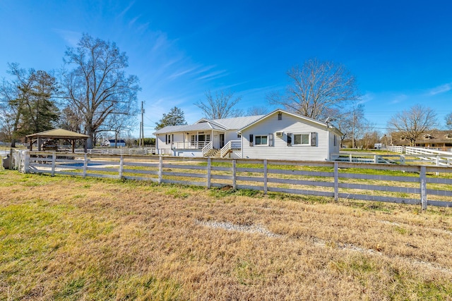 view of front of property featuring a gazebo and a front yard