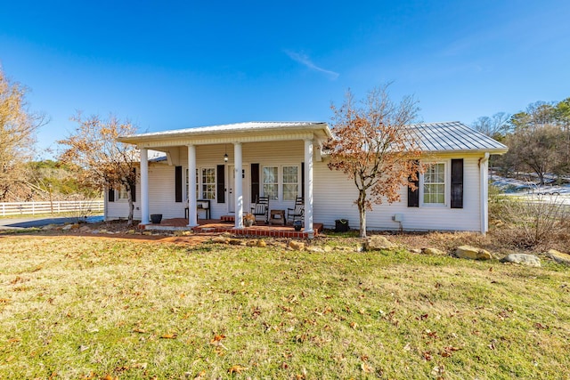 view of front of home with covered porch and a front yard