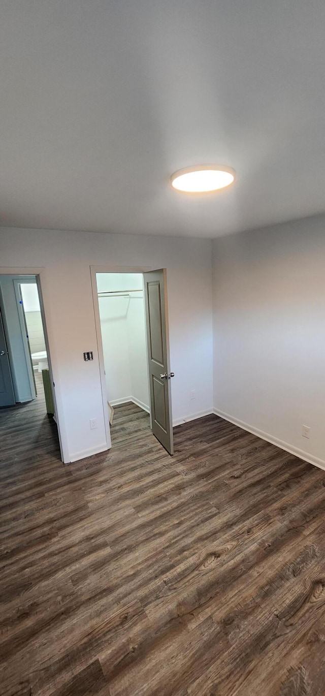 spare room featuring dark wood-type flooring