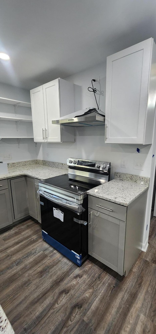 kitchen with white cabinets, stainless steel electric range oven, dark wood-type flooring, and exhaust hood