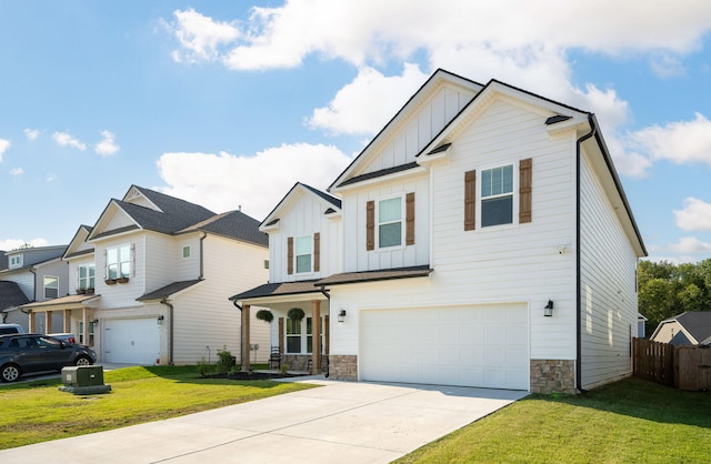 8784 Snowy Owl Rd, Ooltewah, TN 37363 - view of front of house with fence, a front lawn, a garage, board and batten siding, and driveway