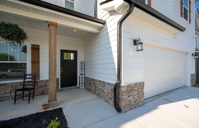 property entrance featuring a porch and a garage