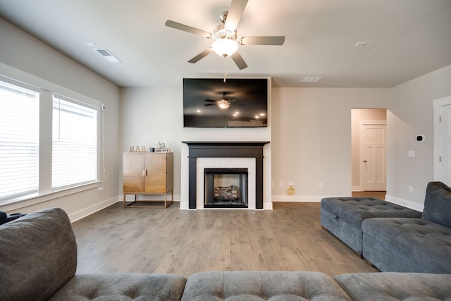 living room featuring ceiling fan and light wood-type flooring