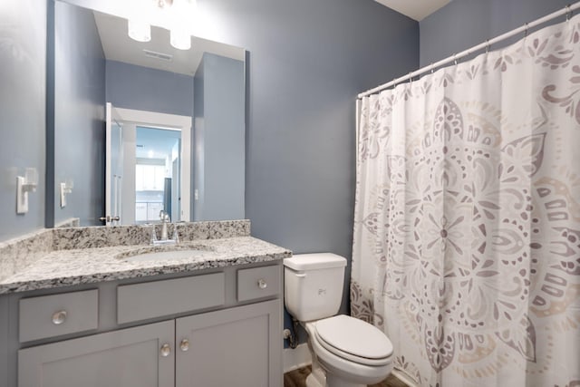 bathroom featuring vanity and toilet