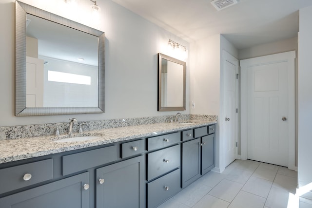 bathroom with tile patterned flooring and vanity