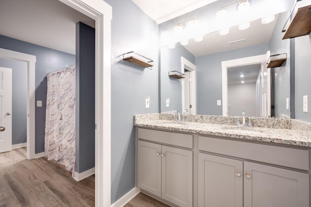 bathroom featuring curtained shower, vanity, and hardwood / wood-style flooring