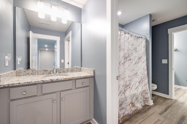 bathroom with a shower with shower curtain, vanity, toilet, and wood-type flooring