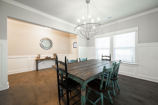 dining room featuring ornamental molding, dark wood-type flooring, and a notable chandelier