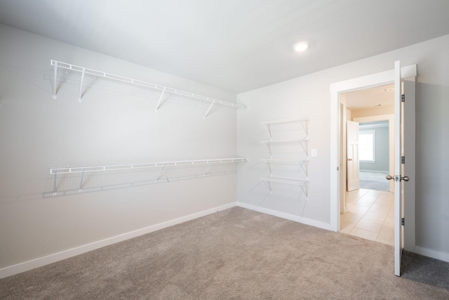 8784 Snowy Owl Rd, Ooltewah, TN 37363 - spacious closet featuring carpet floors and tile patterned flooring