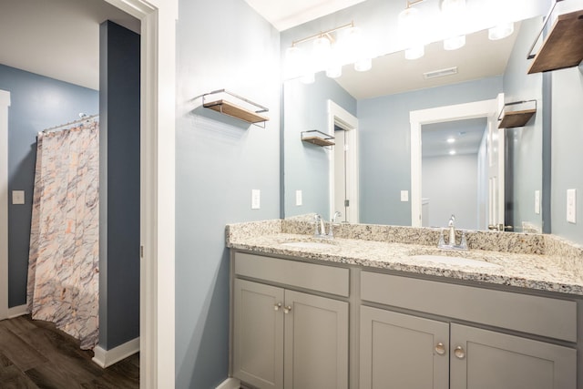8784 Snowy Owl Rd, Ooltewah, TN 37363 - full bath featuring a sink, double vanity, wood finished floors, and visible vents