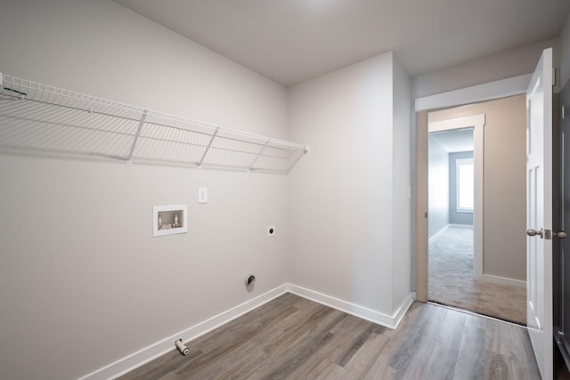 8784 Snowy Owl Rd, Ooltewah, TN 37363 - washroom featuring laundry area, hookup for a washing machine, baseboards, wood finished floors, and hookup for an electric dryer