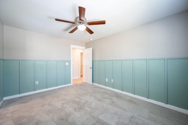 8784 Snowy Owl Rd, Ooltewah, TN 37363 - carpeted spare room with ceiling fan, a decorative wall, and a wainscoted wall