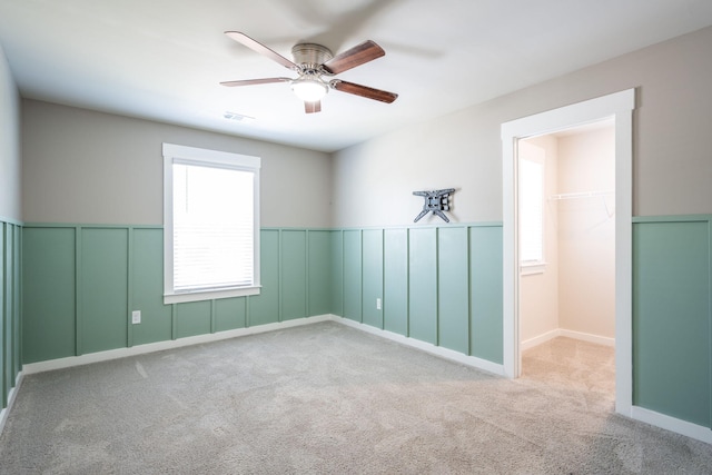 8784 Snowy Owl Rd, Ooltewah, TN 37363 - carpeted empty room with ceiling fan, visible vents, and wainscoting