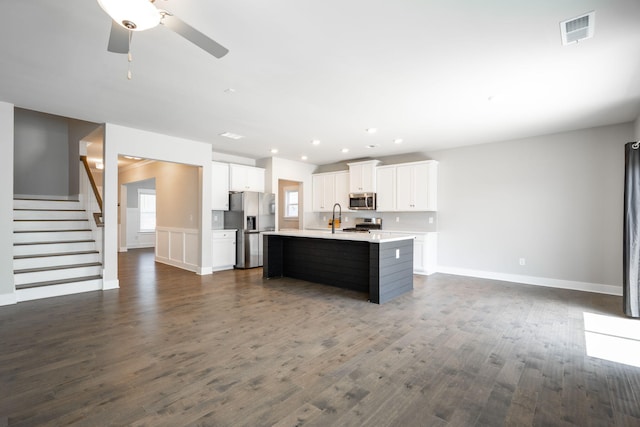 8784 Snowy Owl Rd, Ooltewah, TN 37363 - kitchen featuring visible vents, open floor plan, light countertops, a sink, and appliances with stainless steel finishes