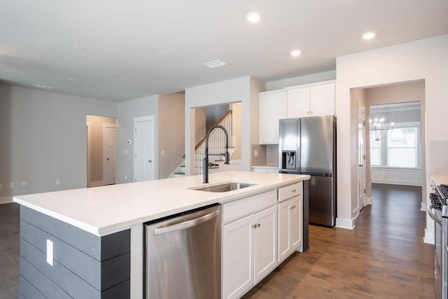 8784 Snowy Owl Rd, Ooltewah, TN 37363 - kitchen featuring baseboards, an island with sink, a sink, dark wood finished floors, and stainless steel appliances