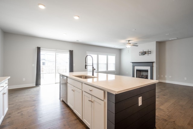 8784 Snowy Owl Rd, Ooltewah, TN 37363 - kitchen with a ceiling fan, a fireplace, dark wood-type flooring, a sink, and dishwasher