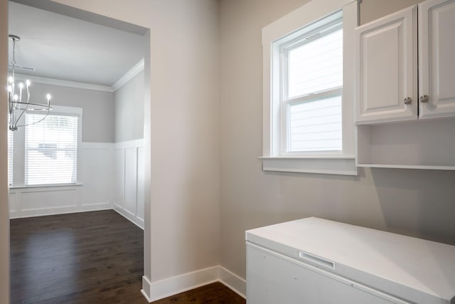 8784 Snowy Owl Rd, Ooltewah, TN 37363 - washroom with crown molding, an inviting chandelier, wainscoting, a decorative wall, and dark wood-style floors