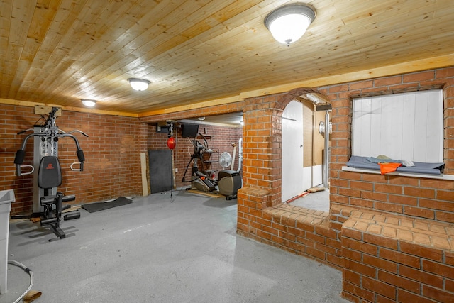 workout area with brick wall and wood ceiling