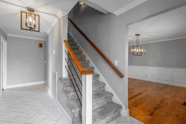 stairs featuring tile patterned floors, an inviting chandelier, and crown molding