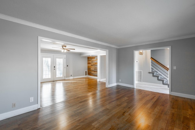 unfurnished living room featuring ceiling fan, french doors, hardwood / wood-style floors, a textured ceiling, and ornamental molding