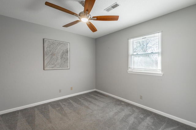 carpeted empty room featuring ceiling fan