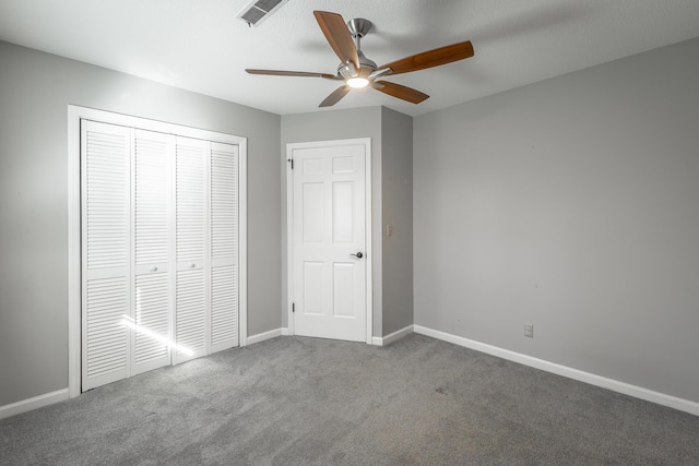 unfurnished bedroom featuring carpet flooring, a closet, and ceiling fan