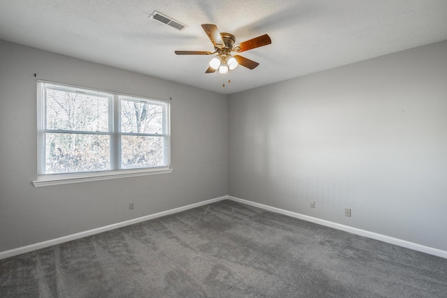 carpeted spare room featuring a textured ceiling and ceiling fan