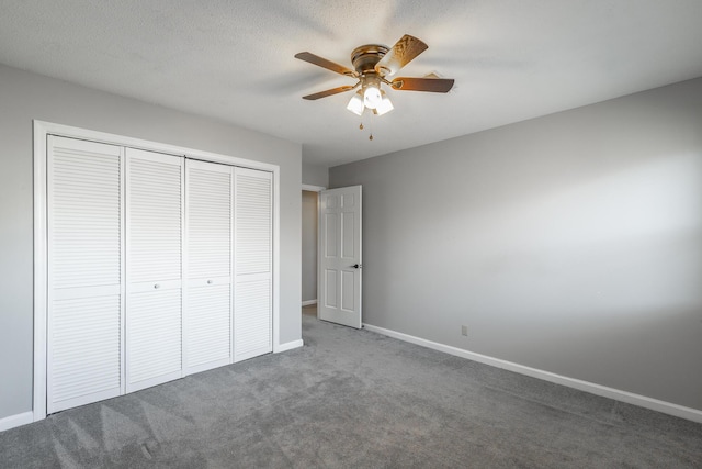 unfurnished bedroom featuring carpet flooring, a textured ceiling, a closet, and ceiling fan