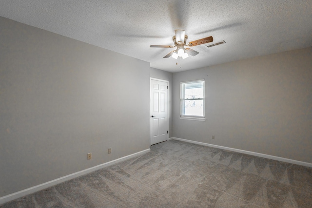 unfurnished room with carpet, a textured ceiling, and ceiling fan