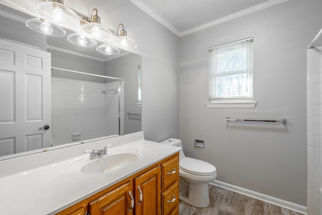 bathroom with ornamental molding, vanity, a shower, hardwood / wood-style flooring, and toilet