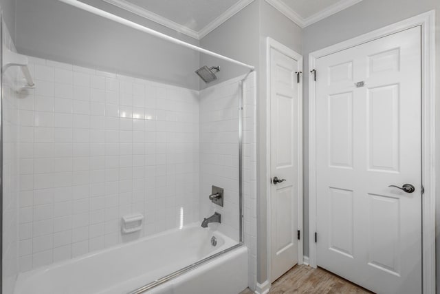 bathroom featuring washtub / shower combination, ornamental molding, and hardwood / wood-style flooring