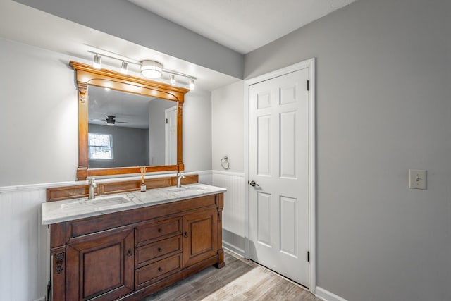 bathroom with ceiling fan, vanity, and wood-type flooring