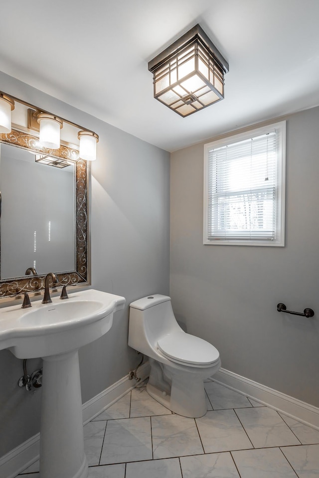 bathroom featuring toilet and sink