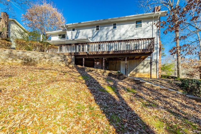 back of house featuring a wooden deck