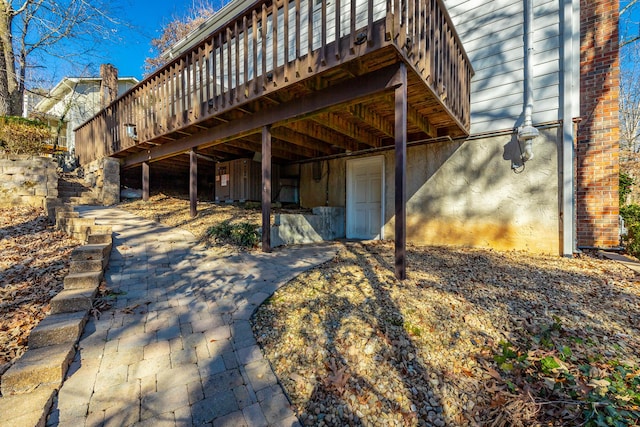 back of house with a wooden deck