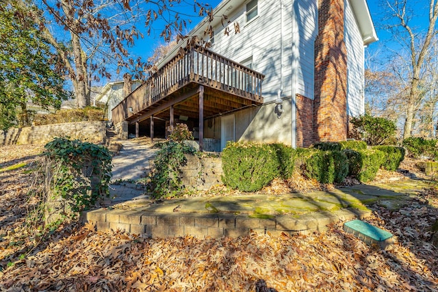 rear view of property featuring a wooden deck