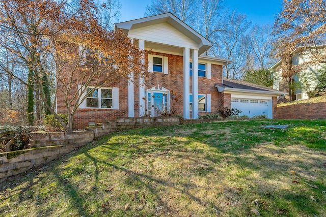 view of front of house featuring a front lawn and a garage