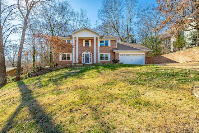 greek revival house featuring a front yard and a garage