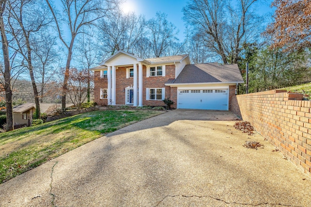 neoclassical / greek revival house with a garage and a front lawn