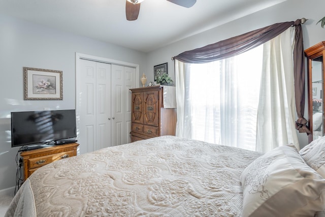 bedroom with ceiling fan and a closet