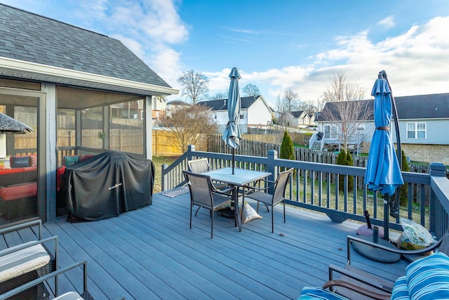 deck featuring grilling area and a sunroom