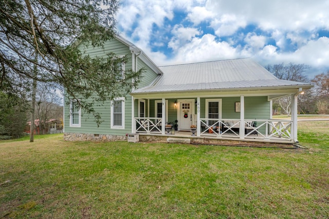 farmhouse-style home with a front yard and a porch