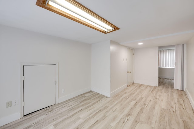 basement with light hardwood / wood-style floors