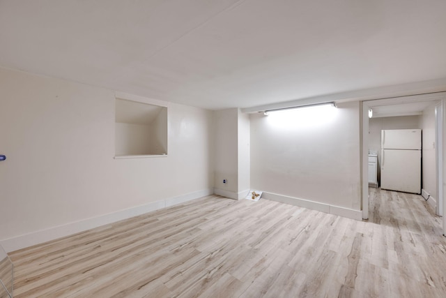 spare room with light hardwood / wood-style flooring