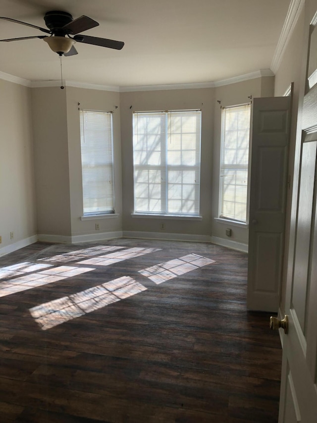 unfurnished room with ceiling fan, crown molding, and dark wood-type flooring