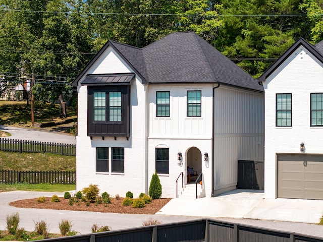 modern inspired farmhouse with a garage